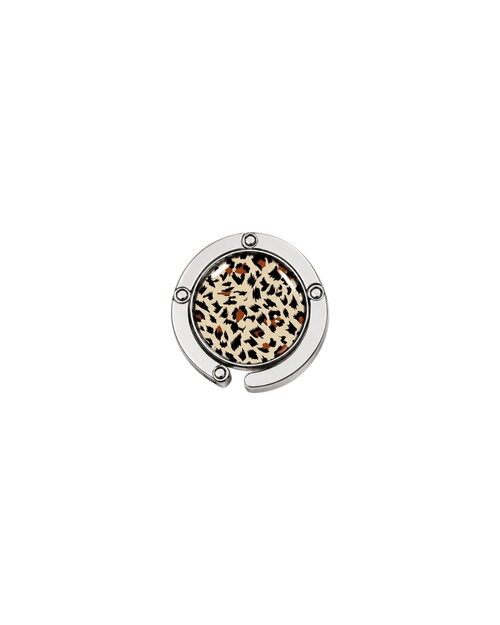 ATORI After Hours circular silver-toned metal handbag hook accessory with a leopard print design, shown on a plain white background.
