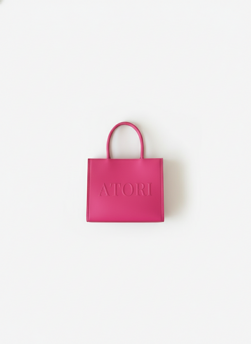 Pink handbag with 'ATORI' branding on a white background