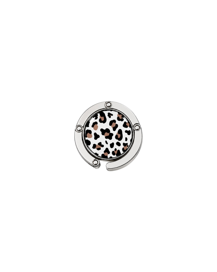 ATORI Unbothered circular silver-toned metal handbag hook accessory with a leopard print design, shown on a plain white background.