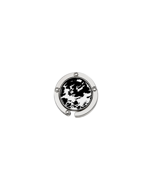 ATORI Untamed circular silver-toned metal handbag hook accessory with a black and white animal print design, shown on a plain white background.
