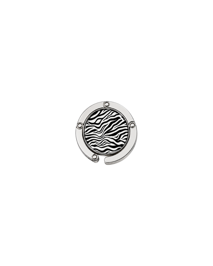 ATORI Main Character Energy circular silver-toned metal handbag hook accessory with a zebra print design, shown on a plain white background.