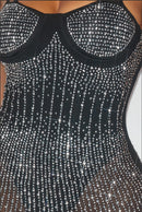 Black sheer rhinestone midi dress with thin straps and low neckline, front view.