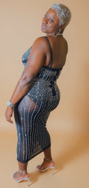 Her Dynasty sheer rhinestone midi dress shown from a side angle.